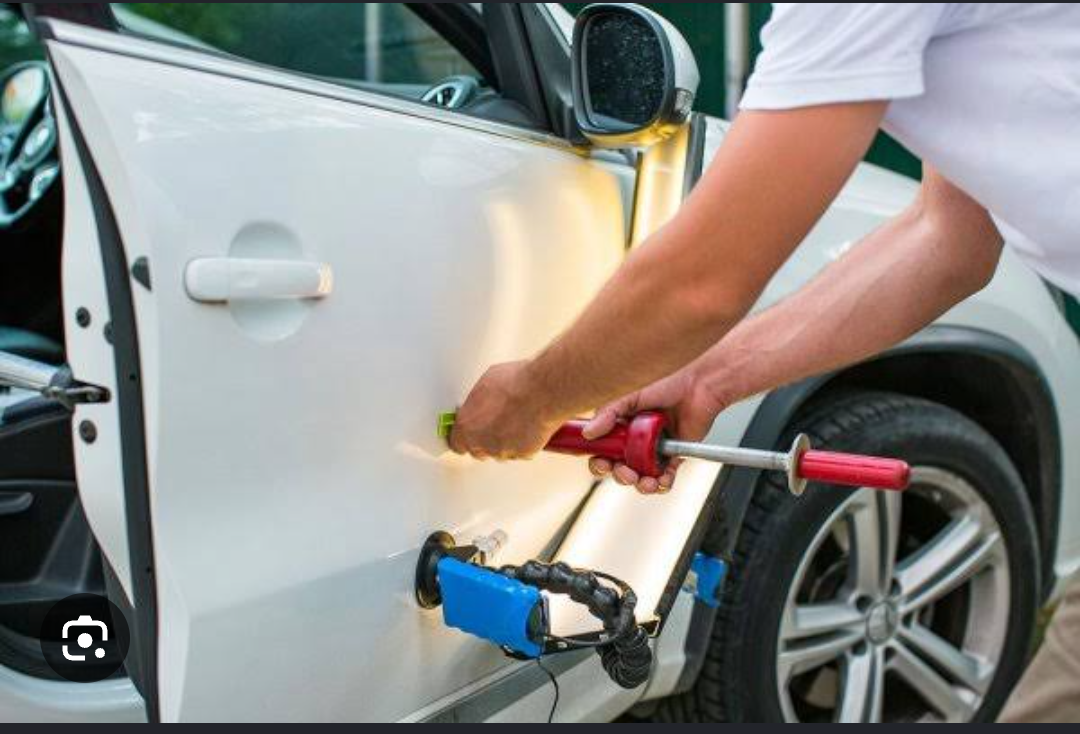 PDR technician performing dent repair
